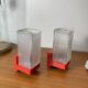 Pair of vintage wall lights in red plastic and clear glass.