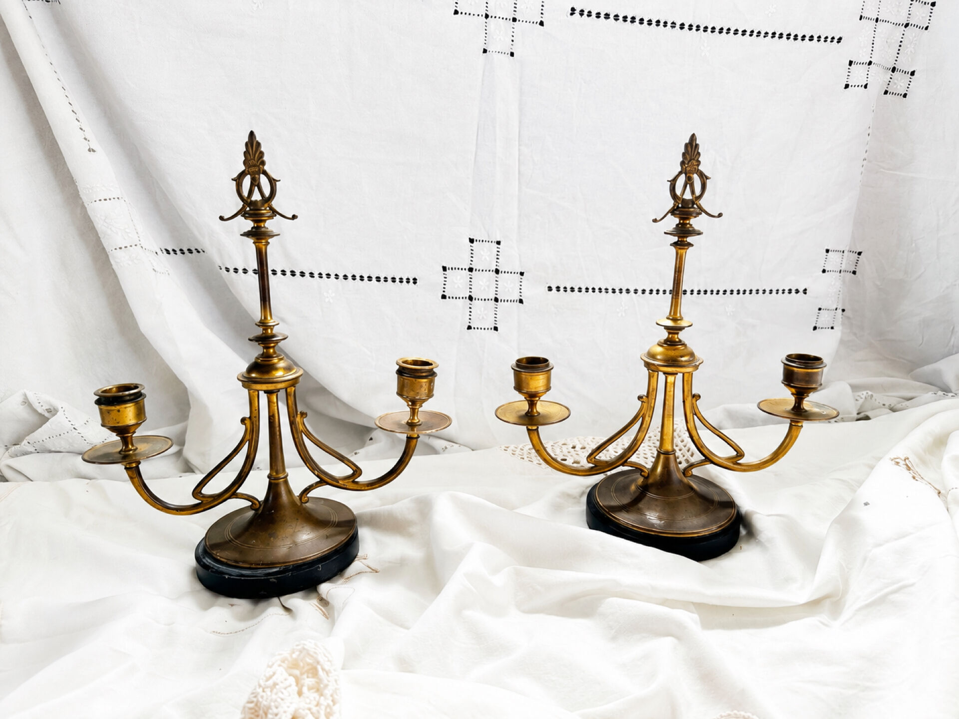 Pair of Empire style candlesticks, patinated brass and black stone.