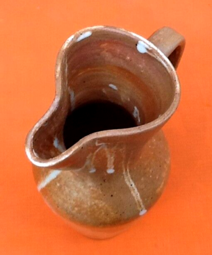 Glazed stoneware pitcher With white dripping on brown background Height: 270mm