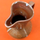 Glazed stoneware pitcher With white dripping on brown background Height: 270mm