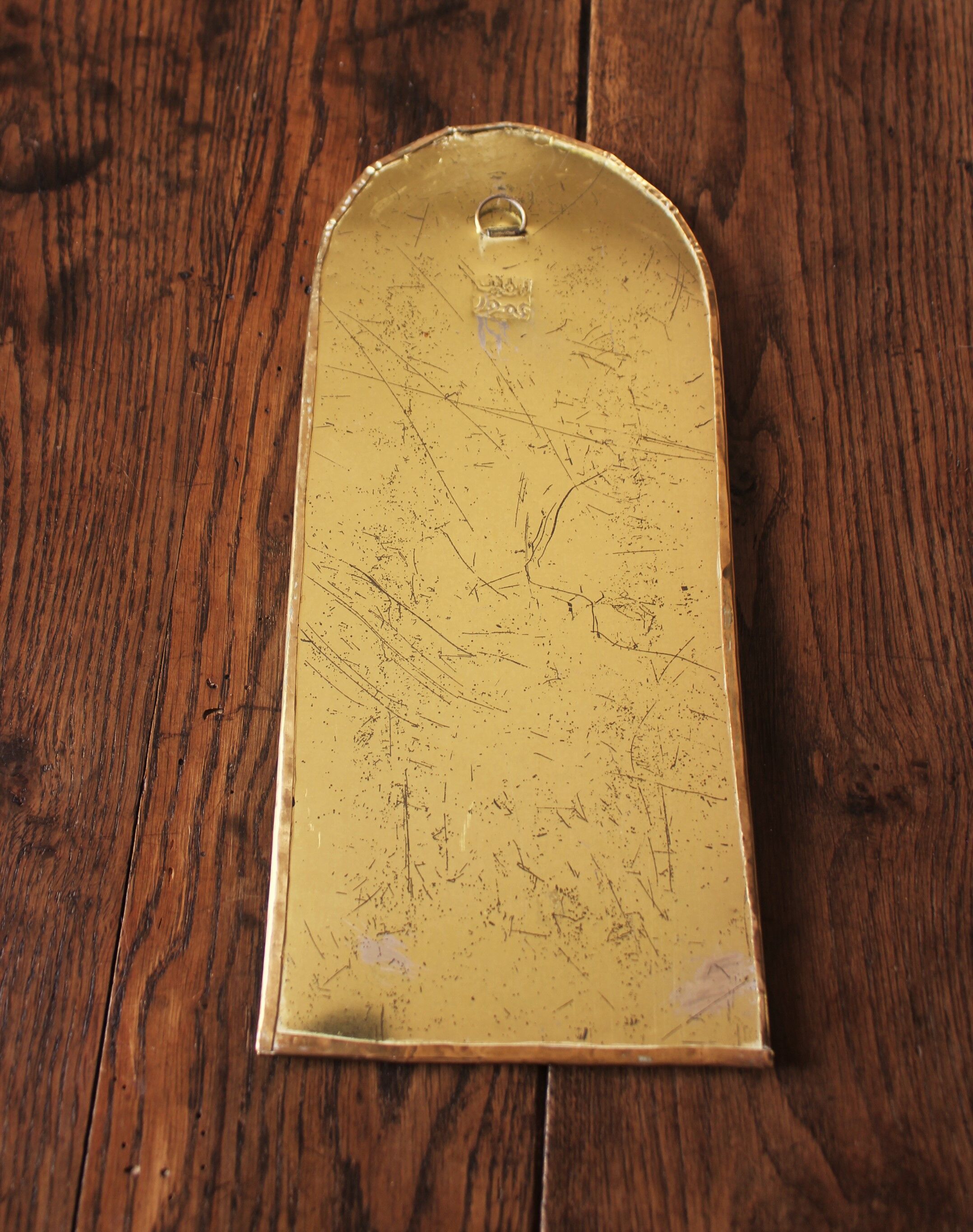 Rounded brass mirror