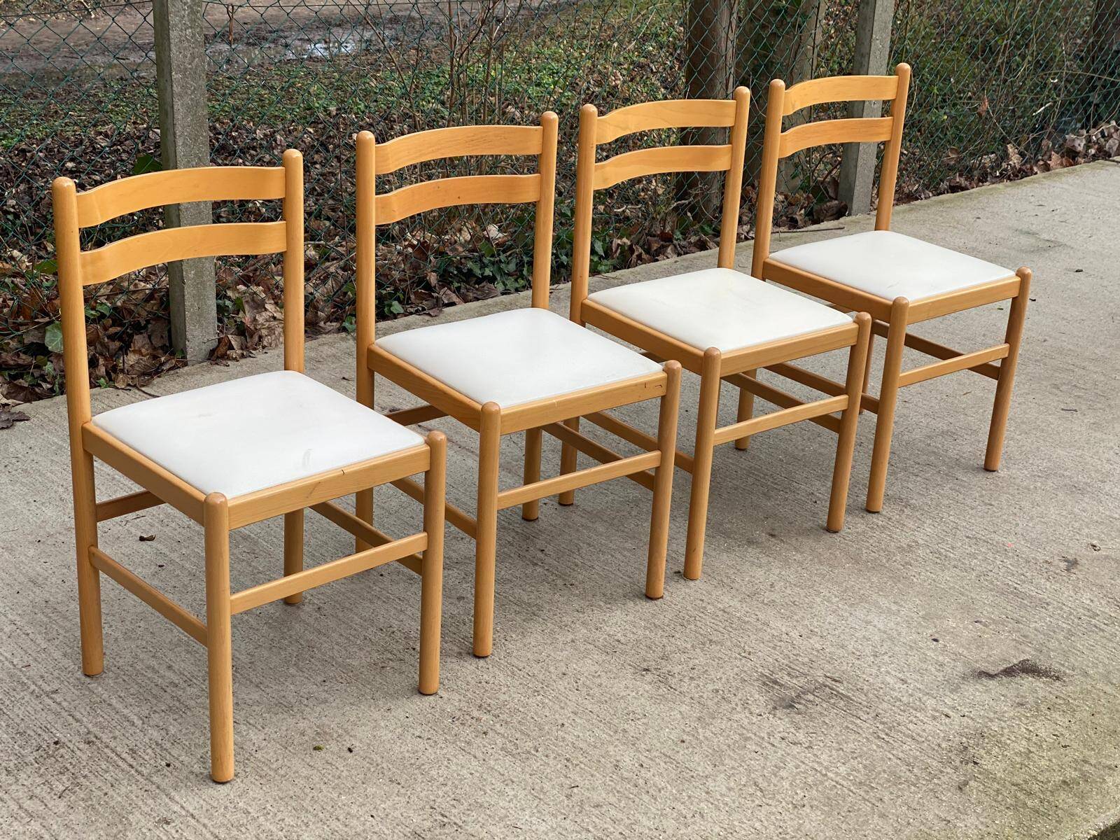 4 solid wood and white leather chairs