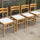 4 solid wood and white leather chairs