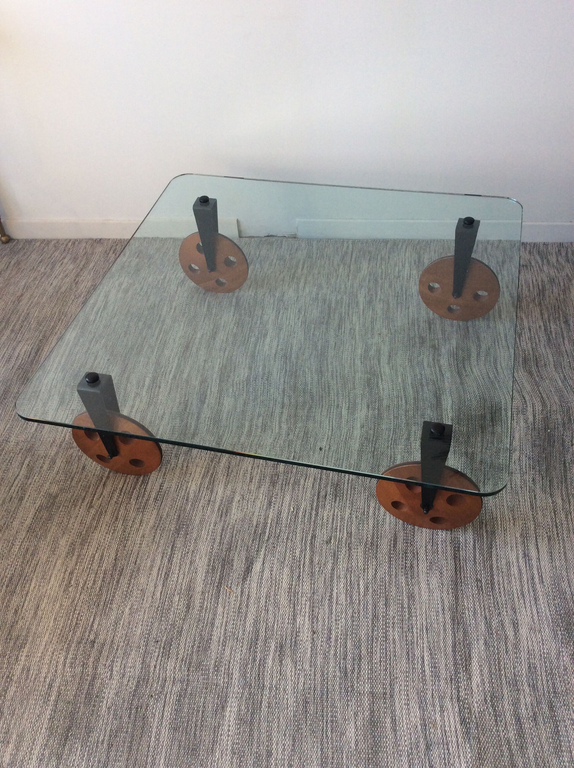 Glass coffee table on teak wheels