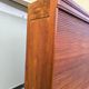 Vintage 1940s secretary desk with wooden curtains, storage, and shutters.