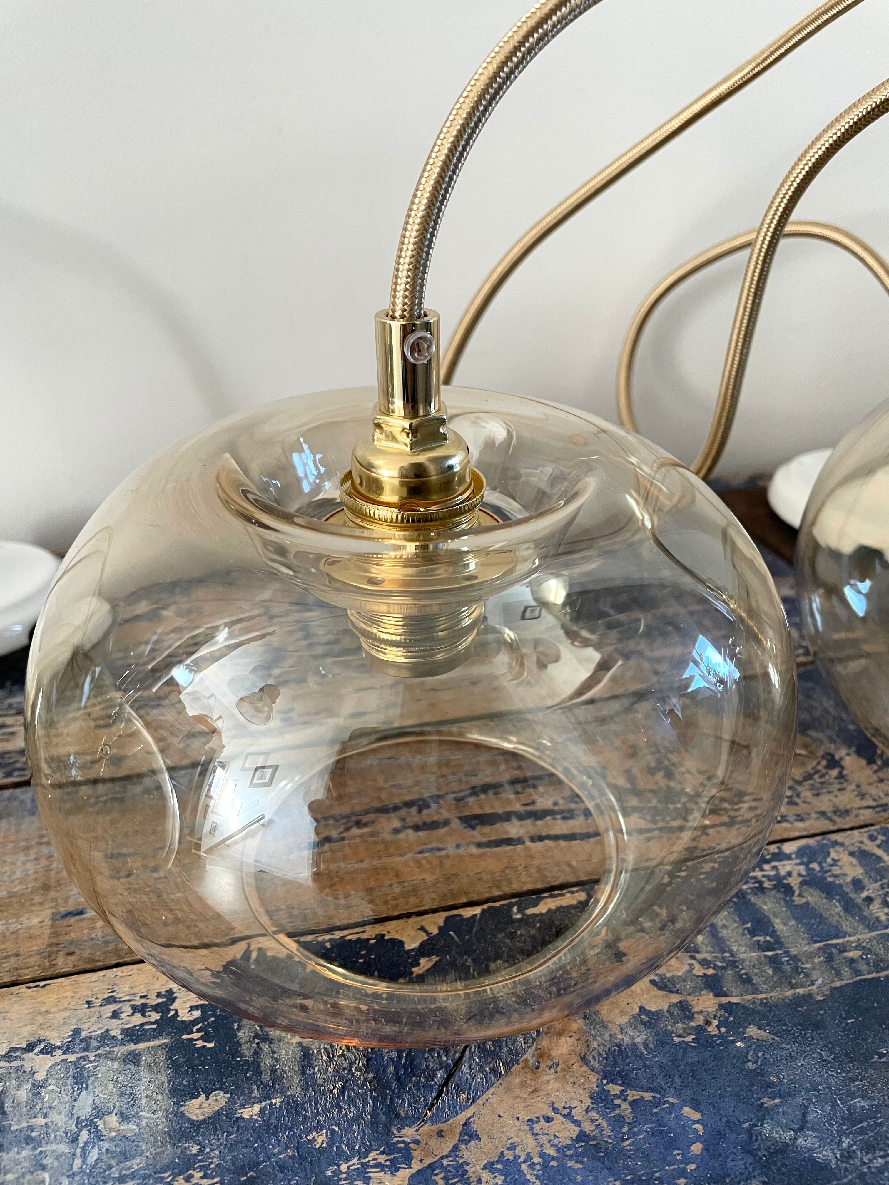 Set of three new electrified golden glass pendant lamps