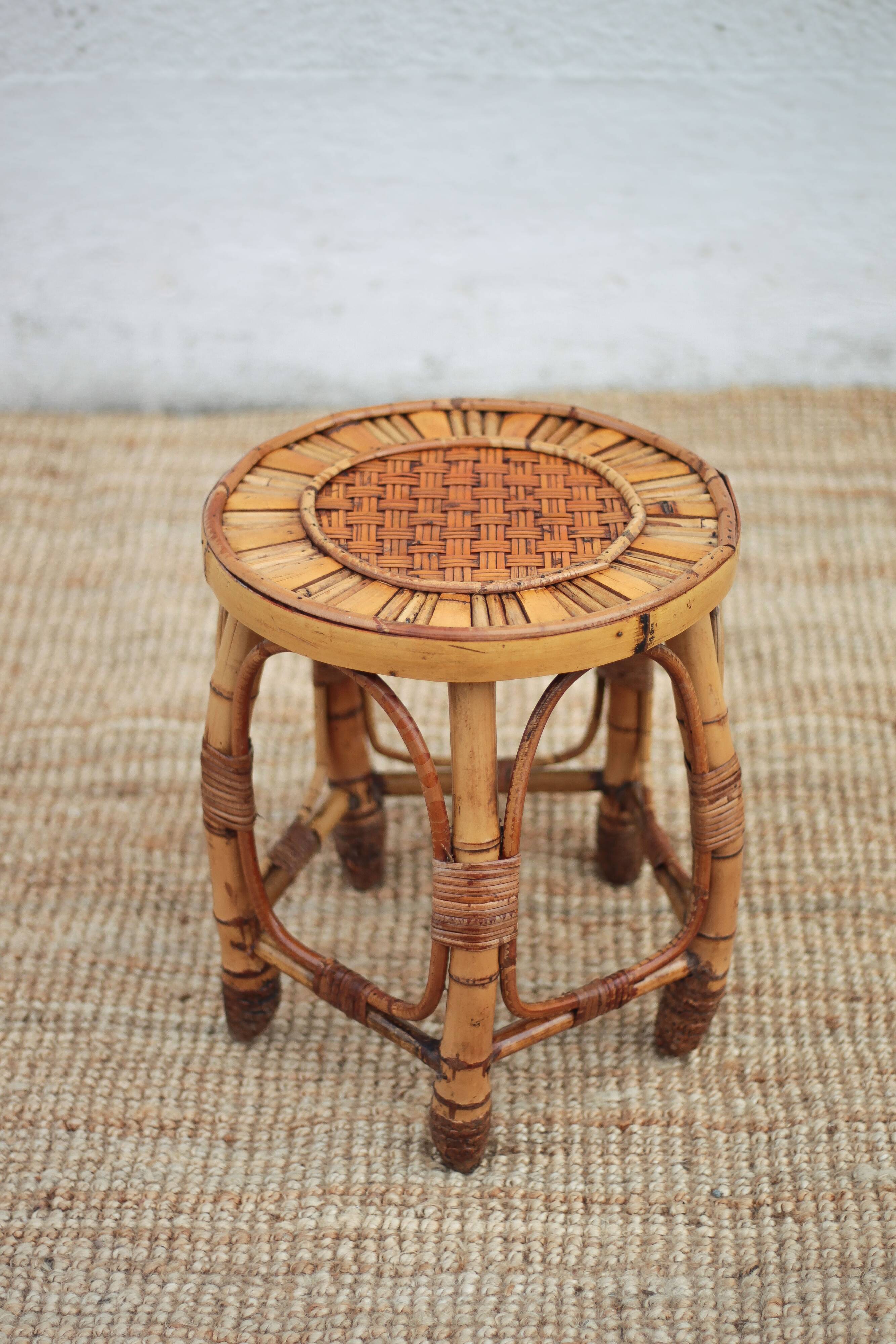 Vintage bamboo stool, woven rattan plant stand, interior decoration.