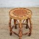 Vintage bamboo stool, woven rattan plant stand, interior decoration.