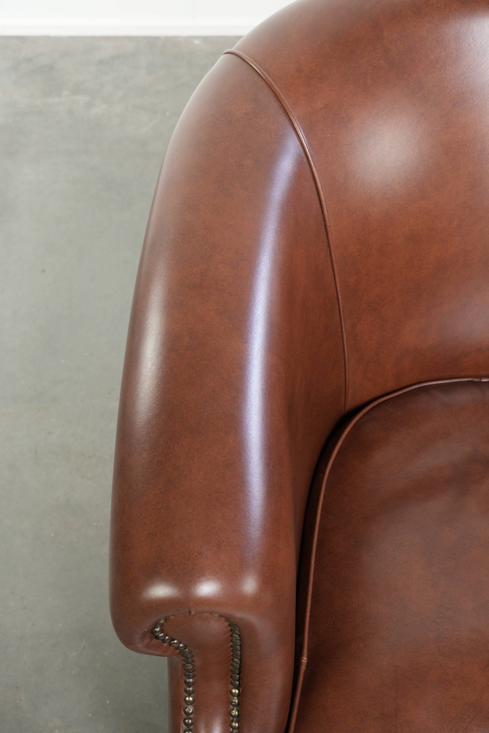 Cognac-coloured comfortable cow leather club armchair in English style