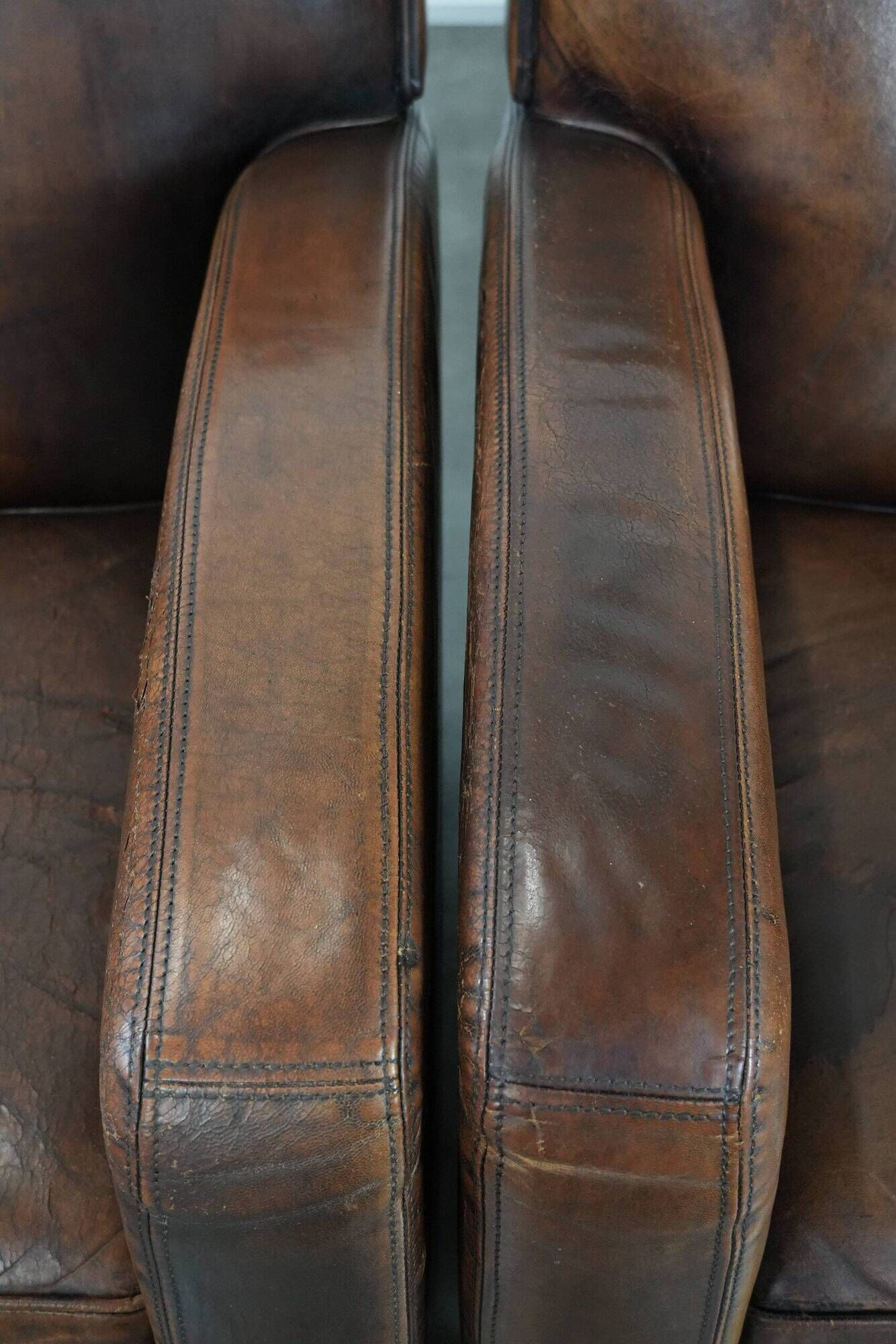 Characterful set of two vintage sheepskin armchairs with beautiful colours