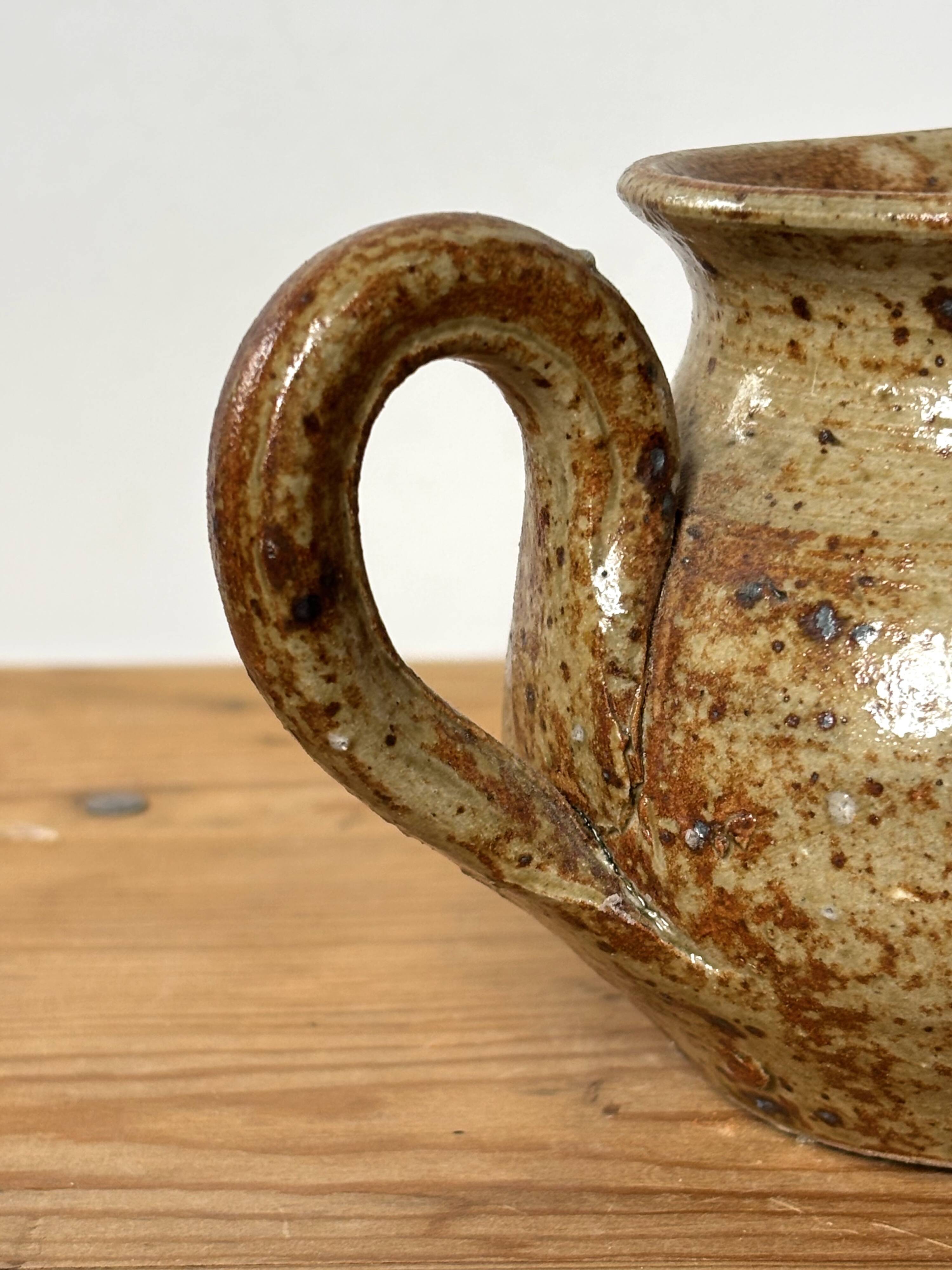 Small beige speckled stoneware pitcher
