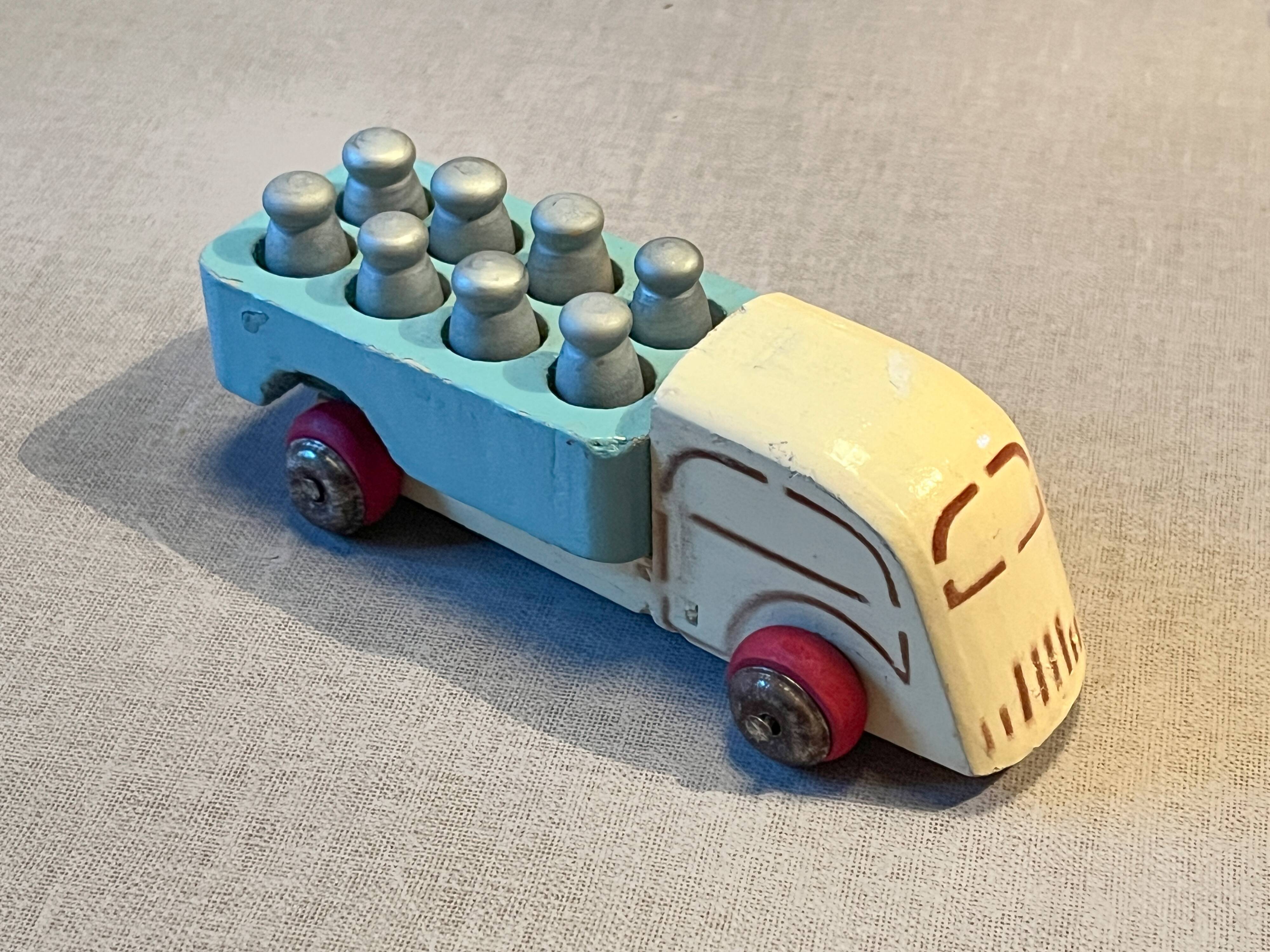 Small wooden milk truck with its cans, antique toy