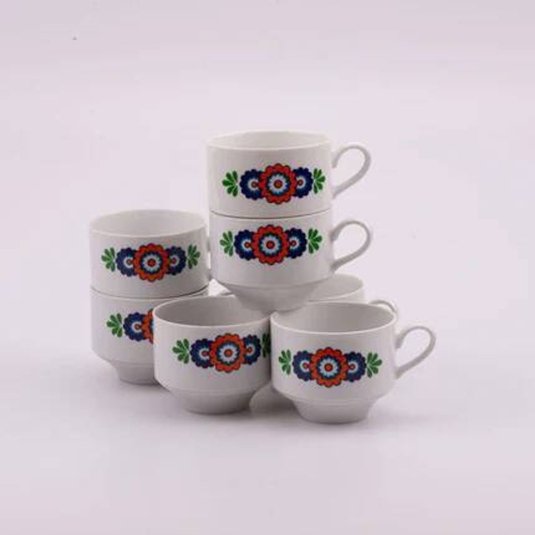7 white porcelain cups from Winterling with coloured patterns.