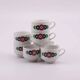 7 white porcelain cups from Winterling with coloured patterns.
