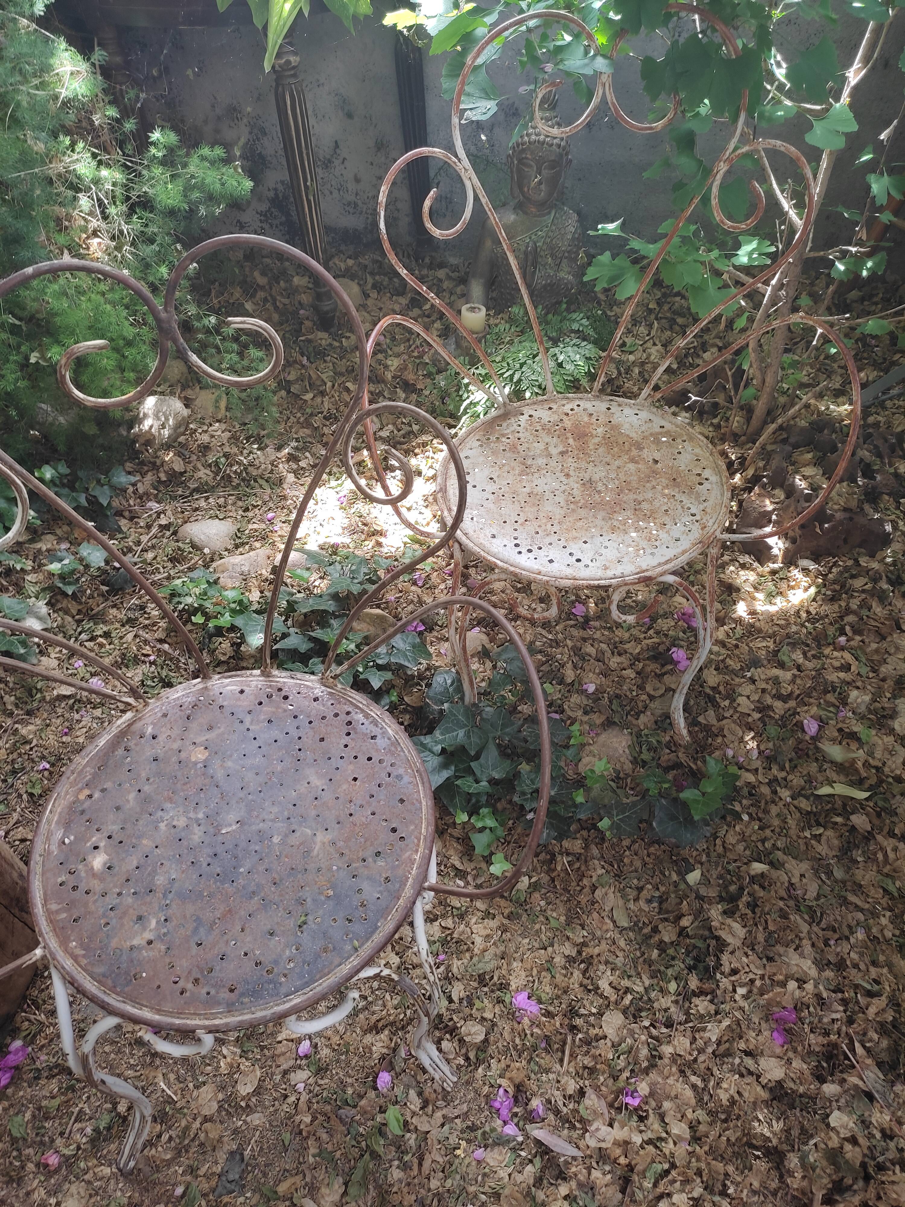 Duo of iron lawn chairs