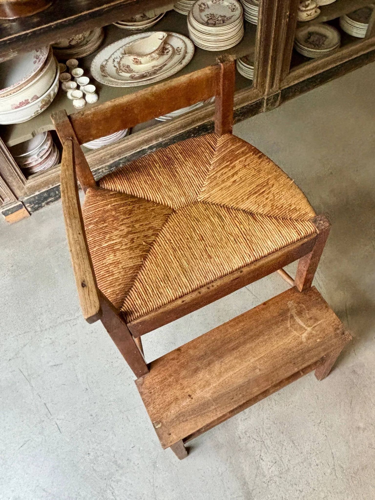 High chair made of wood and straw.