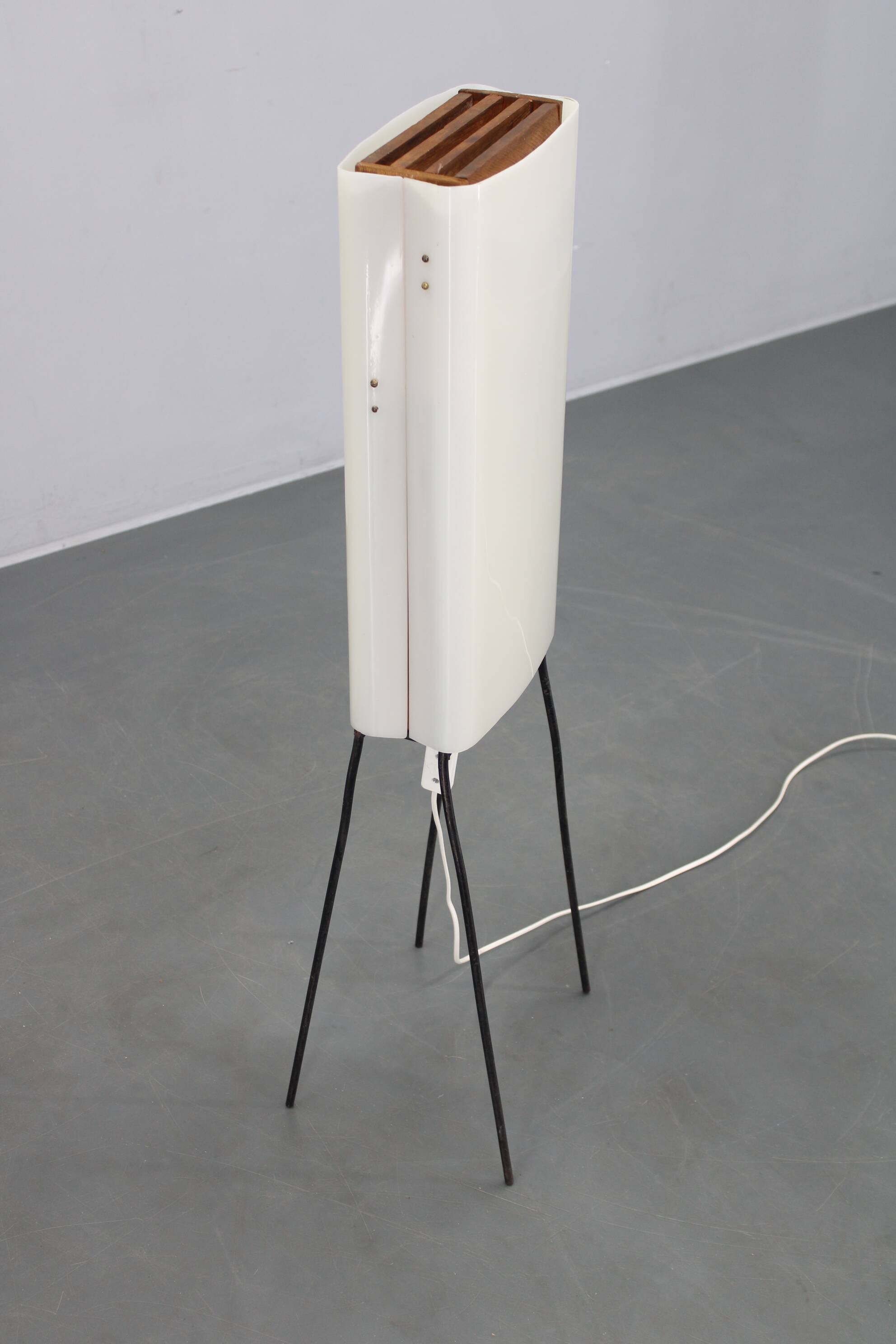 Mid-century modern floor lamp on iron legs with plastic shade and wood accent