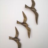 Birds stylized in brass