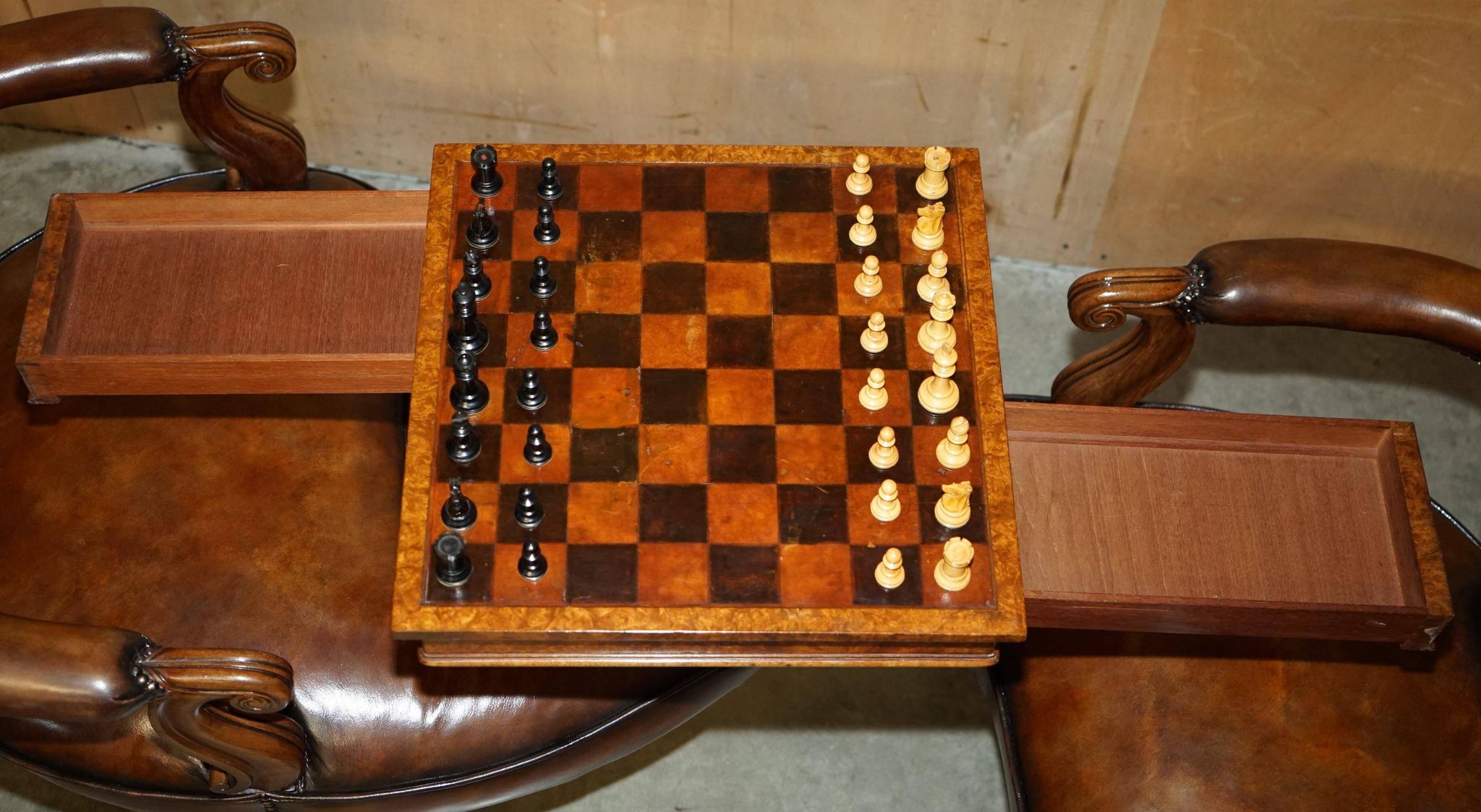 High Victorian leather tête-à-tête canapé with a walnut burr chessboard.