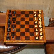 High Victorian leather tête-à-tête canapé with a walnut burr chessboard.