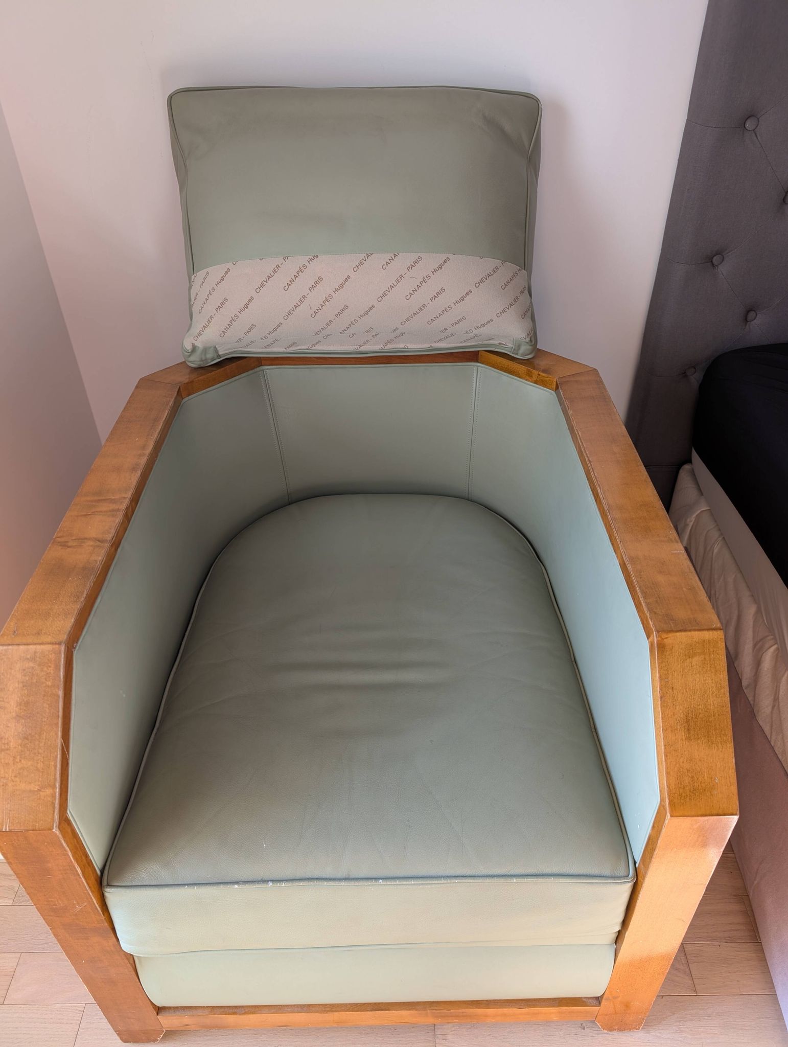 Vintage armchair Hugues Chevalier Paris — Almond green leather & Wood