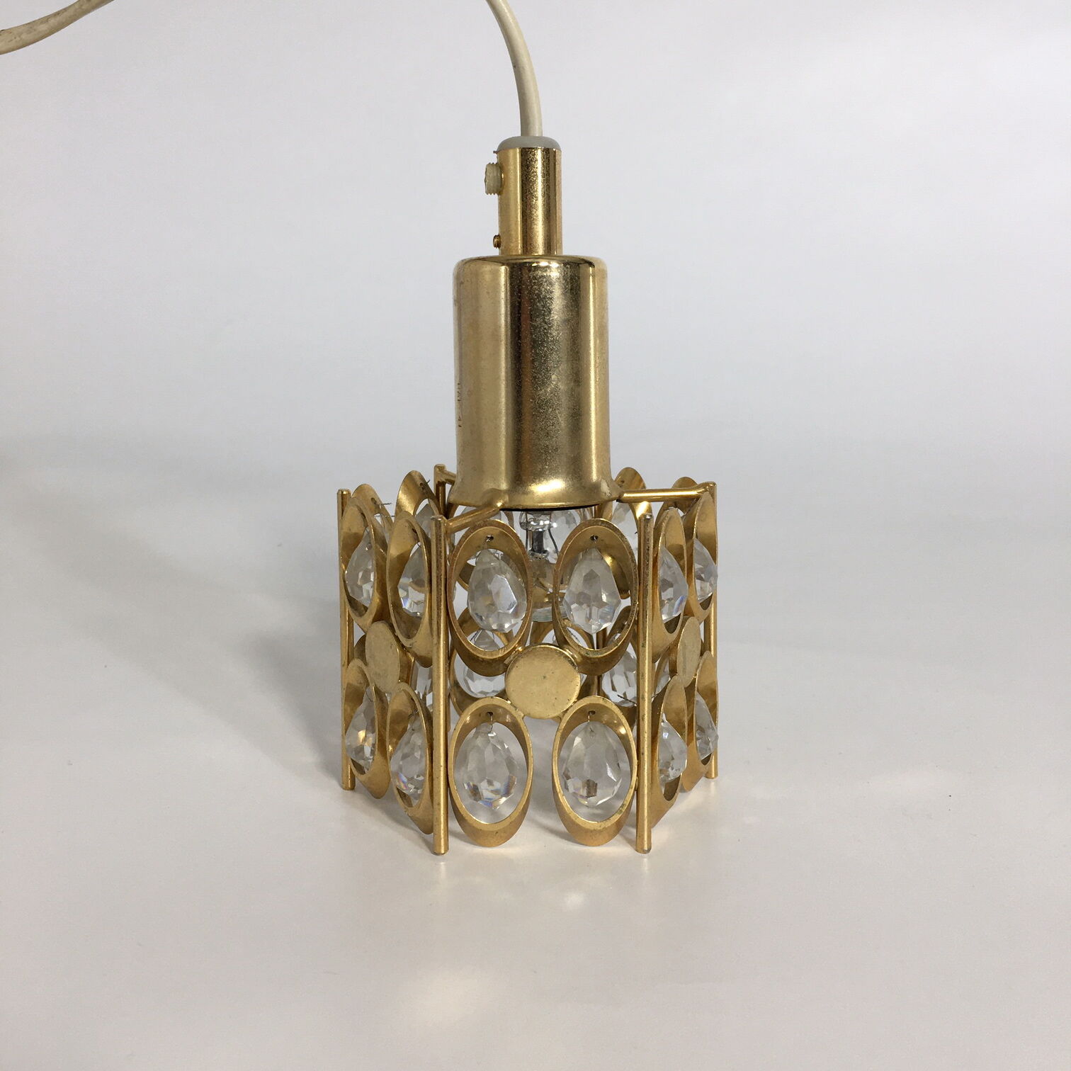 Two pendant lights in gilded brass and crystal, by Palwa, design 1960