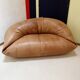 Two-seater leather pouf sofa by Raphaël Raffel for Honoré Paris