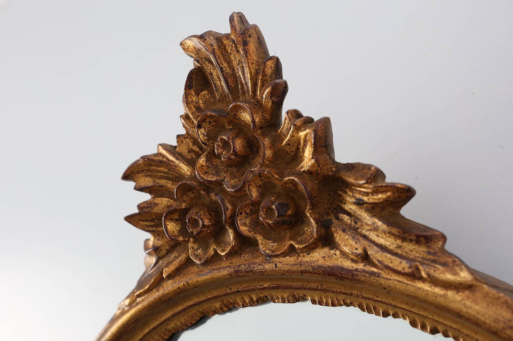 20th Century Louis XVI style giltwood mirror with ornate crest, France