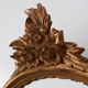 20th Century Louis XVI style giltwood mirror with ornate crest, France