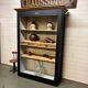 Patinated chestnut cabinet bookcase