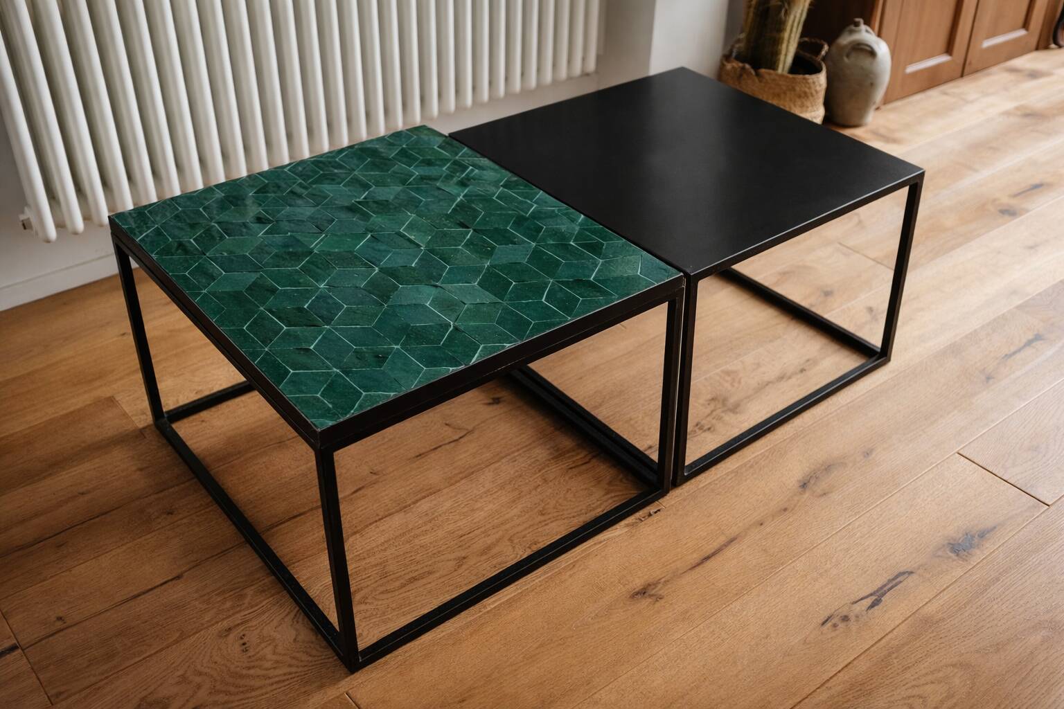 A pair of wrought iron side tables with emerald green Moroccan zellige.