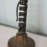 Candle holder with iron and wood pusher