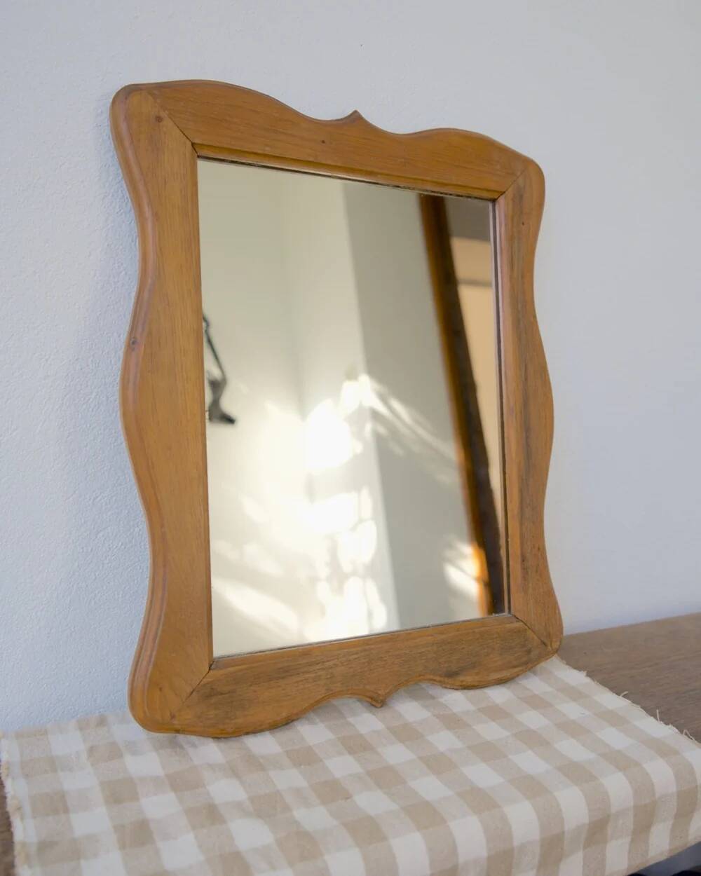 Wooden mirror with a shaped frame