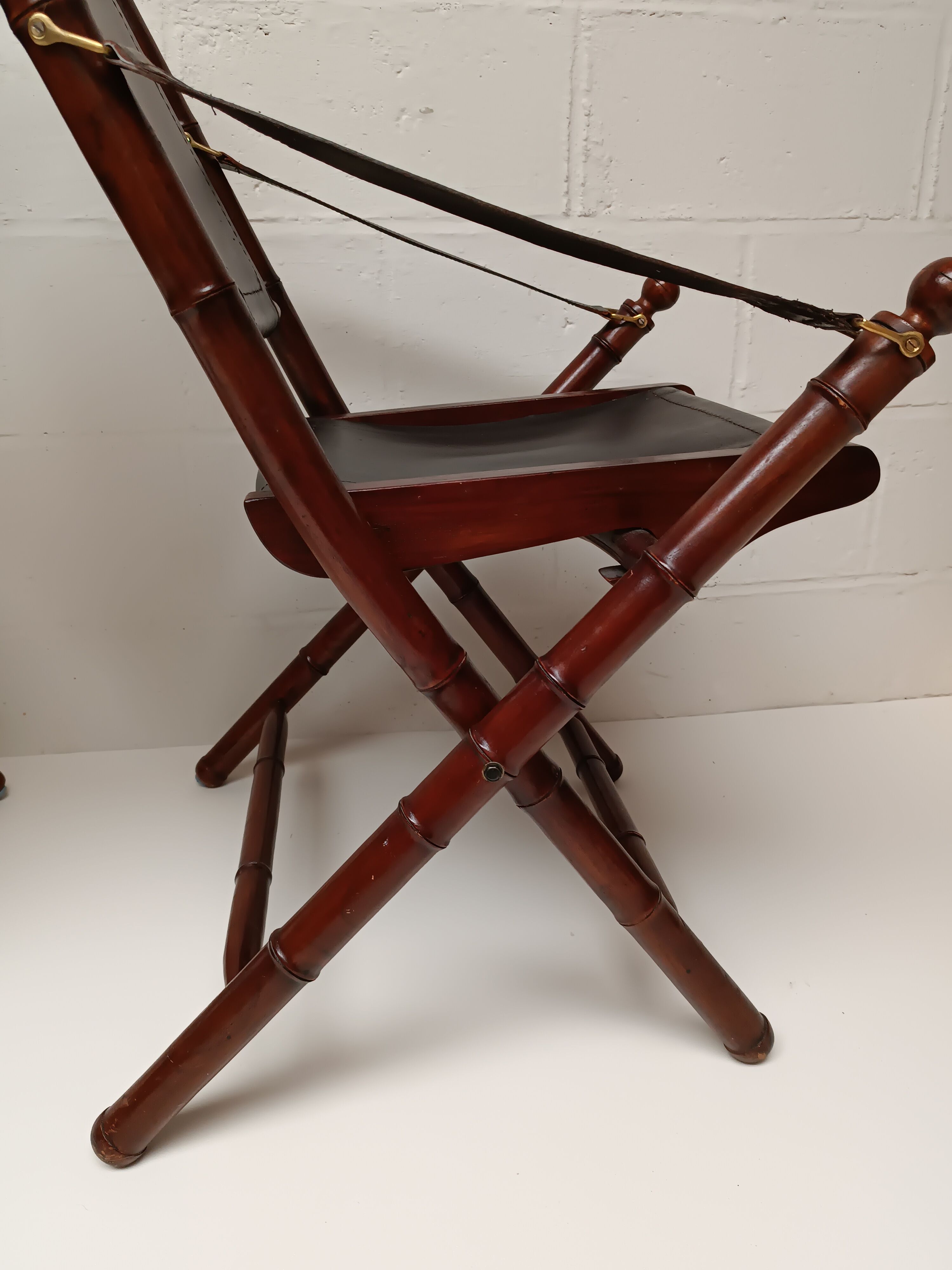 Pair of vintage "safari" folding armchairs in mahogany and leather