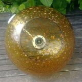 A vintage 70s blown glass pendant light with gold glitter in a globe shape