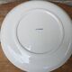 Old ceramic plate with scene of life and blue floral decor Van Melle