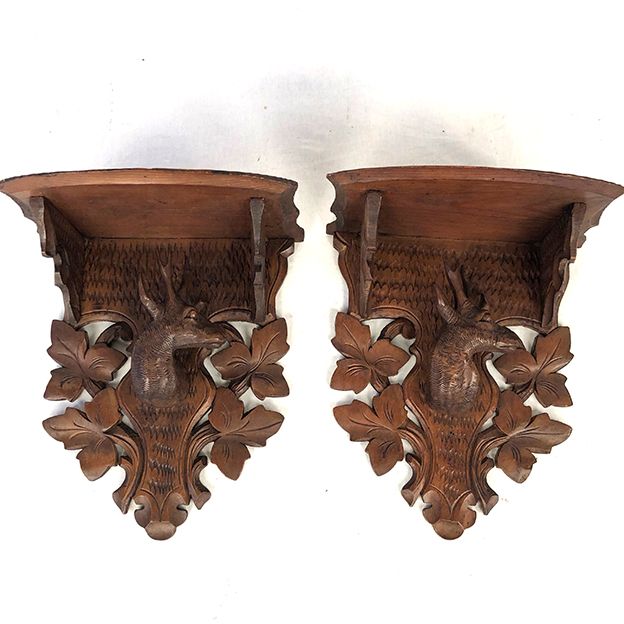 Pair of carved wooden wall consoles decorated with a deer's head