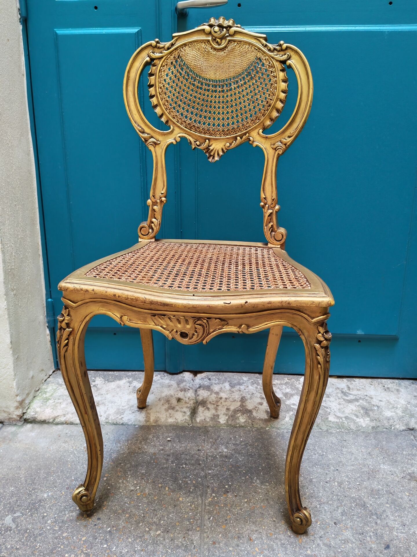 Antique rococo chair in gilded wood and caning