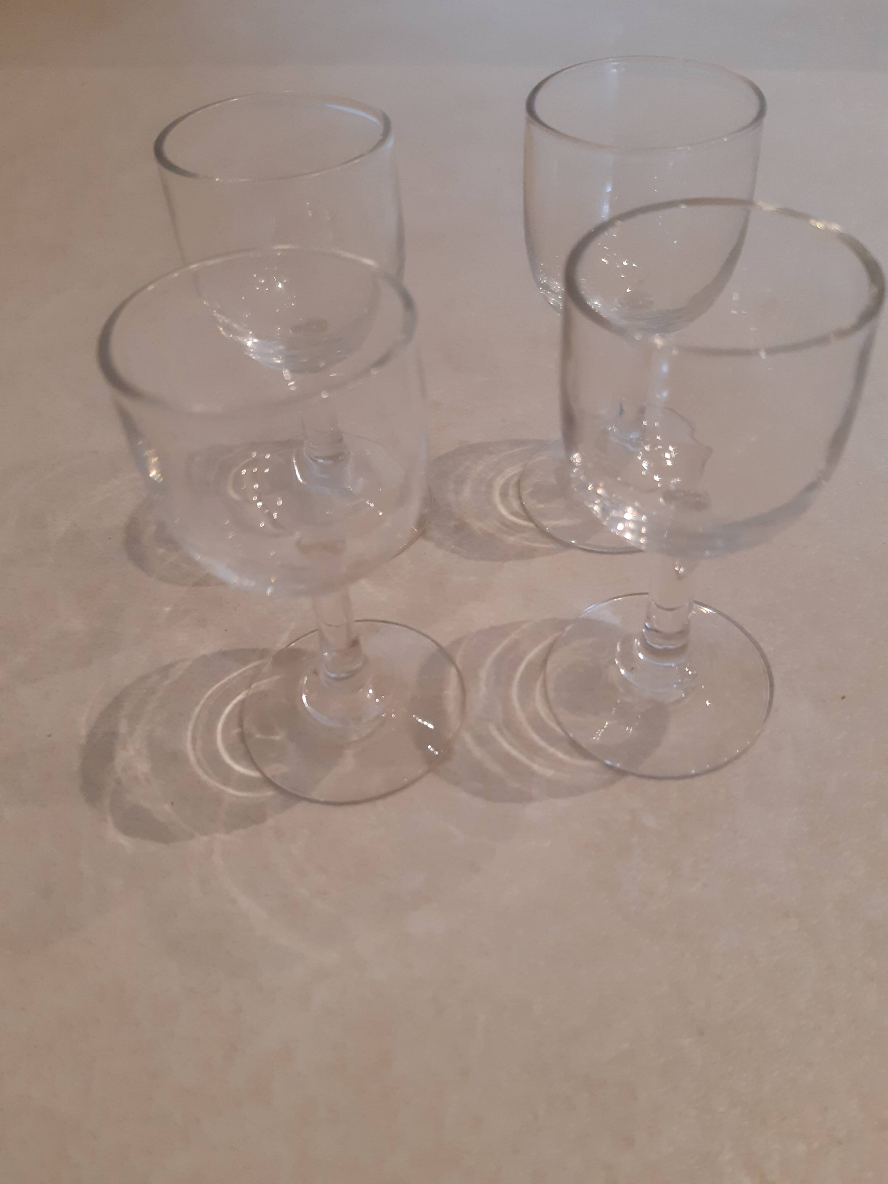 Set of 4 small stemmed glasses for strong alcohol.