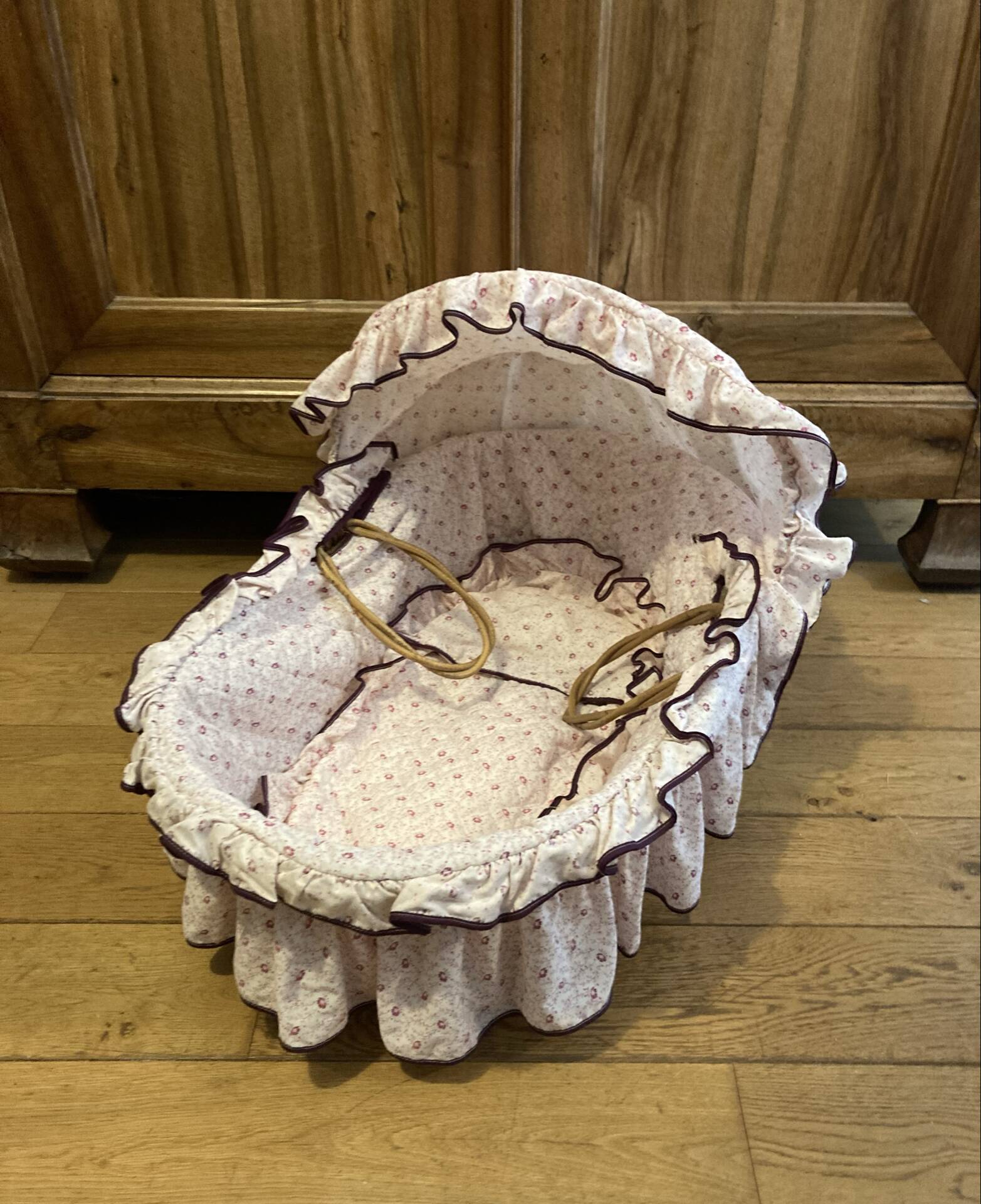 1960s wicker cradle with mattress and drapes.