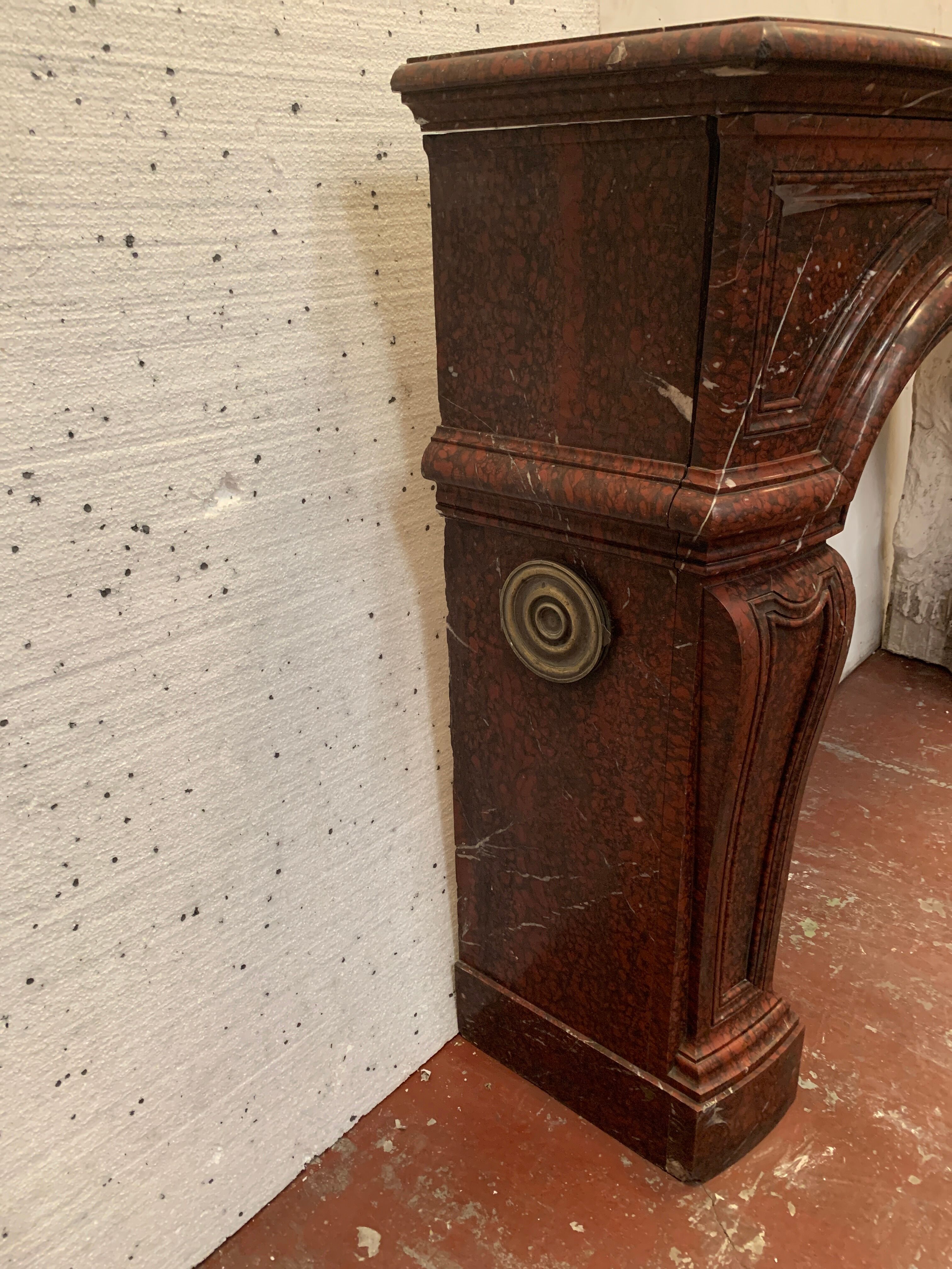 Pair of Louis XIV style fireplaces in red cherry marble. XIX century.