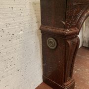 Pair of Louis XIV style fireplaces in red cherry marble. XIX century.