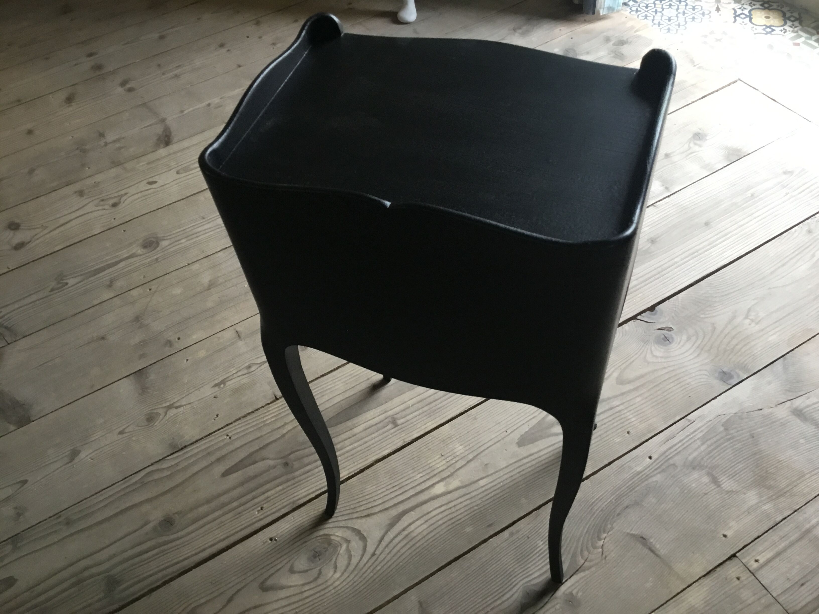 Bedside or nightstand painted black with patterns