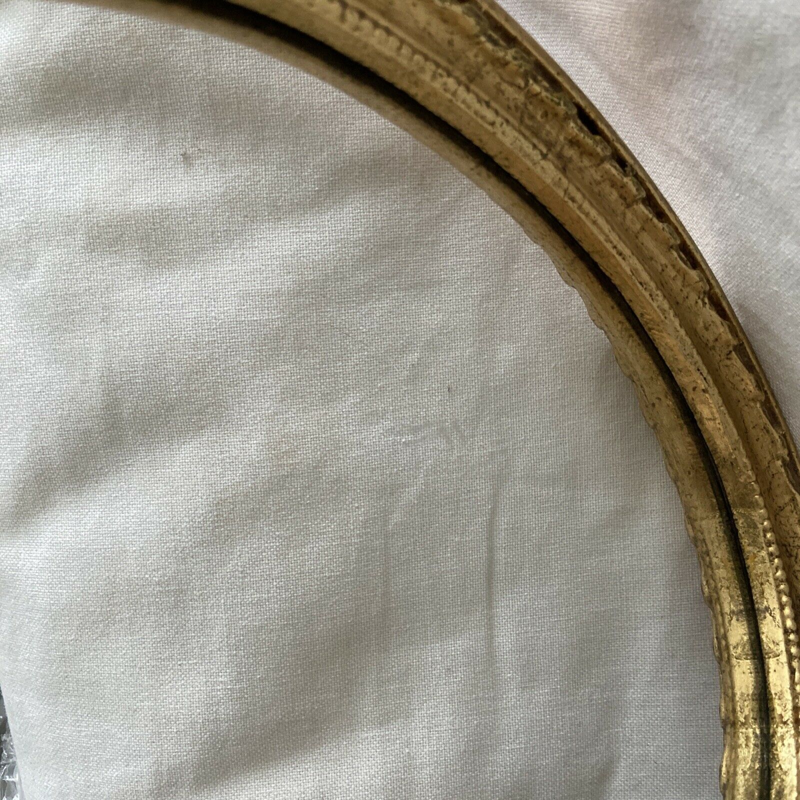 Oval wall mirror in baroque gilded plaster frame 29x20cm