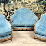 Art deco living room around 1920 in carved wood upholstered in blue velvet, a sofa two armchairs