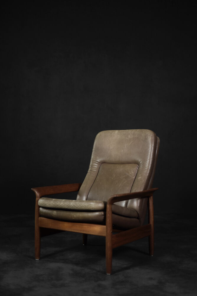 High teak and brown leather armchair with reclining backrest, mid-century Danish style, 1960s.