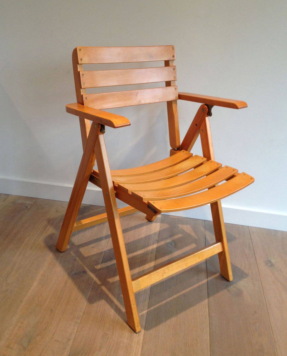 Pair of varnished wooden folding armchairs signed Clairitex.