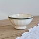 Old ivory ceramic bowl with double green trim.