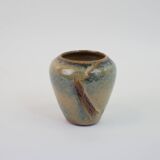 Small beige glazed ceramic vase with abstract relief pattern