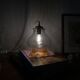 Vintage tulip-shaped portable lamp in transparent glass and gold.